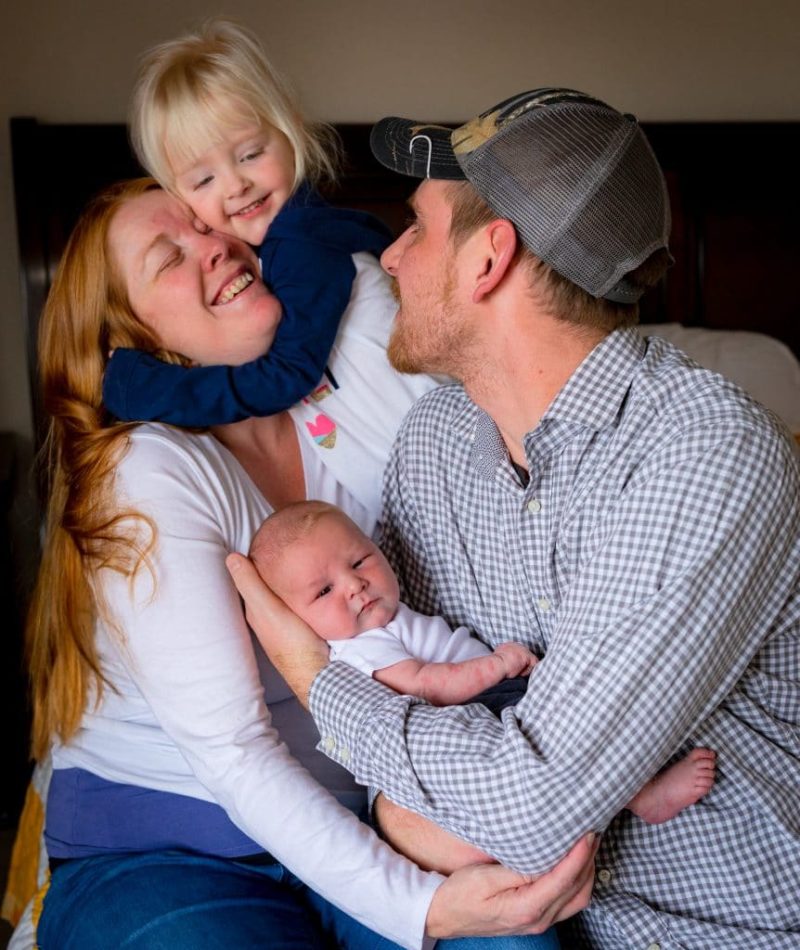 family cuddling during newborn lifestyle portraits