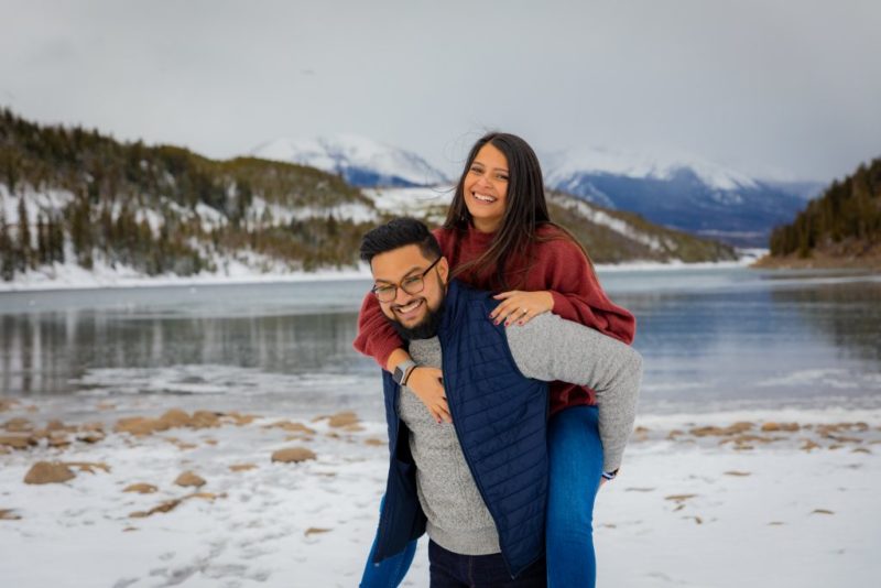 couple playing in snow at Breckenridge engagement portrait spot